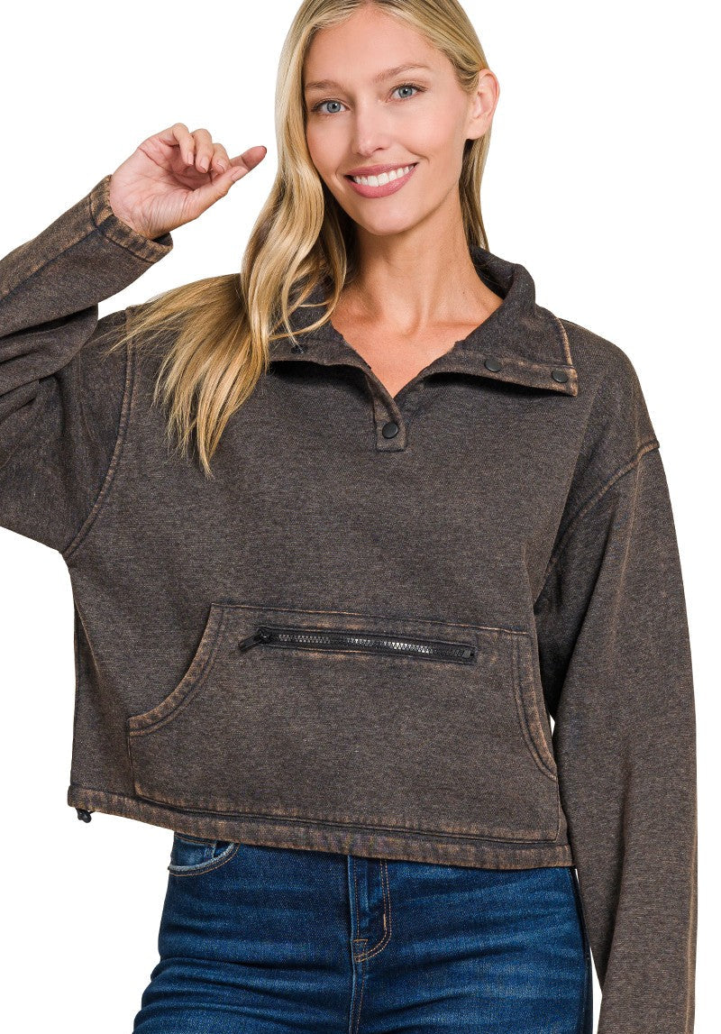 Woman wearing a ash black pullover with a zipper pocket on a white background
