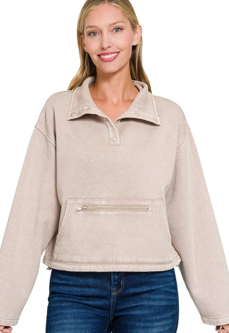 Woman wearing a beige pullover with a white background