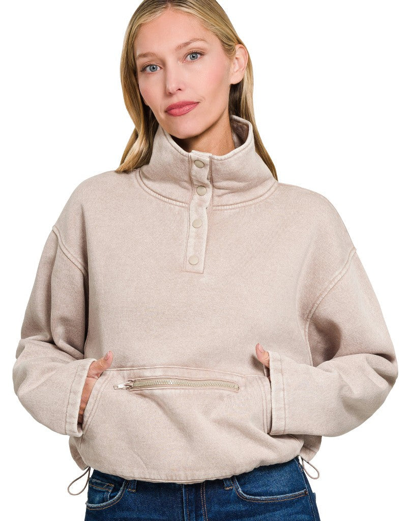 Woman wearing a beige pullover with a white background
